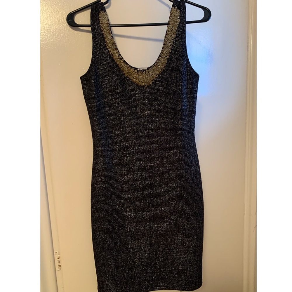 Dress with gold coloured beads around neck